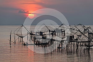 A giant square fishing net, Yor, with beautiful sunrise scenery at Pakpra canal,Phatthalung, Thailand