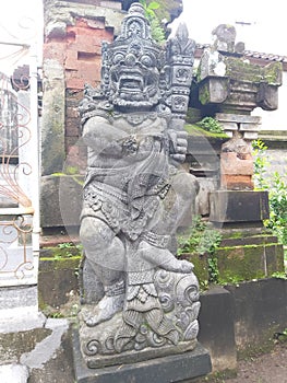 giant statue of stone with characteristic Balinese carvings