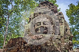 Giant stone face on an ancient temple in Angkor Wat, Siem Rep Cambodia