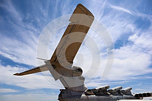 Giant tail of Lun-class Ekranoplan floatplane - unique soviet weaponry against blue sky