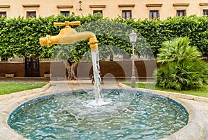 A giant tap suspended on the historic fountain of the Villa San Giuseppe in Terrasini, Sicily