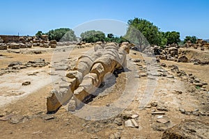 Giant Telamon, Atlas supporting statue of ruined Temple of Zeus in the Valley of Temples - Agrigento, Sicily, Italy