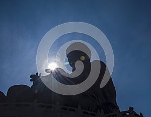 Giant Tian Tan Buddha statue silhouette with sunlight on hand hongkong china