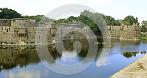 Giant wall and fort battlements with reflection in trench