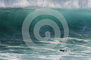 Giant wave and a lone surfer