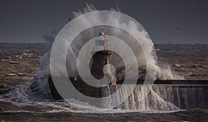 Giant waves batter the 15metre tall lighthouse which guards the south pier at the mouth of the Tyne at South Shields, England