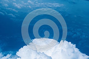 Giant white cumulonimbus clouds against the background of the bright deep blue sky in tropical summer