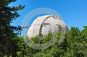 Giant white dome of the reflecting telescope covered with rust at the Observatory