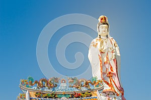 Giant white Guanyin statue with blue sky background. Guanyin or Guan Yin is an East Asian bodhisattva of Mahayana Buddhists and Ch