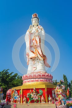 Giant white Guanyin statue with blue sky background. Guanyin or Guan Yin is an East Asian bodhisattva of Mahayana Buddhists and Ch