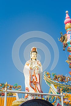 Giant white Guanyin statue with blue sky background. Guanyin or Guan Yin is an East Asian bodhisattva of Mahayana Buddhists and Ch