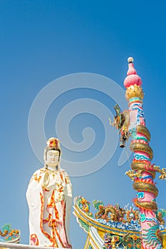 Giant white Guanyin statue with blue sky background. Guanyin or Guan Yin is an East Asian bodhisattva of Mahayana Buddhists and Ch