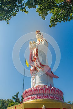 Giant white Guanyin statue with blue sky background. Guanyin or Guan Yin is an East Asian bodhisattva of Mahayana Buddhists and Ch