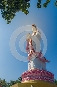 Giant white Guanyin statue with blue sky background. Guanyin or Guan Yin is an East Asian bodhisattva of Mahayana Buddhists and Ch