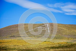 Giant White A Made Out of Rocks on a Hillside in Montana