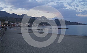 Giardini Naxos beach with Taormina in the background, Sicily, Italy