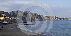 Giardini Naxos beach with Taormina in the background, Sicily, Italy