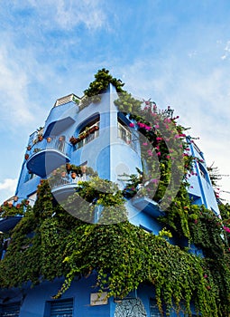 Giardini Naxos blue hotel covered in greenery, Sicily