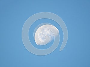 Gibbous moon in blue sky