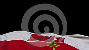 Gibraltar fabric flag waving on the wind loop. Gibraltar embroidery stiched cloth banner swaying on the breeze. Half-filled black