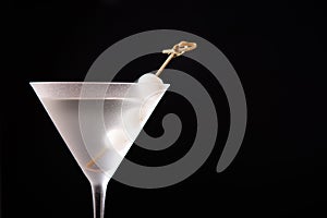 Gibson martini cocktail with onions on black background