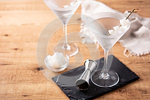 Gibson martini cocktail with onions on wooden table