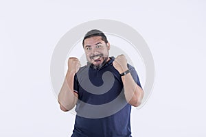 A giddy bearded man reacting after hearing great news. Expressing victory
