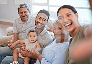 Giddy with pride. a family taking a selfie while sitting on a sofa at home.