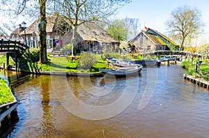 Giethoorn, Netherlands: Landscape view of famous Giethoorn village with canals and rustic thatched roof houses.