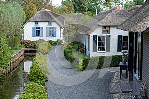 Giethoorn village with canals and rustic thatched roof houses in farm area