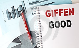 GIFFEN GOOD text on a notebook with pen on a chart background