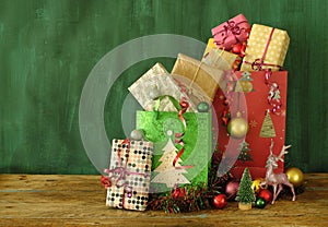 Gift bags with christmas gifts, decoration, christmas baubles and christmas tree,free copy space