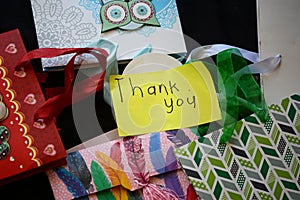 Gift bags with colorful stringers and a thank you note.