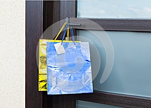 Gift bags hang on the handle of the front door.