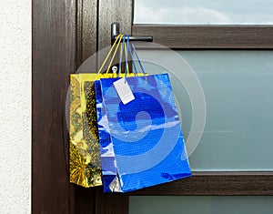 Gift bags hang on the handle of the front door