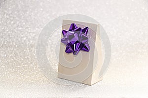 Gift with bow, jewelry and cosmetics for women on brilliant background