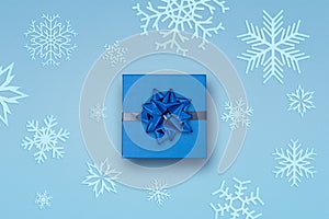 Gift with bow and snowflakes background