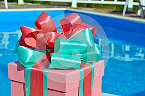 Gift box against the background of the pool.
