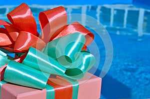 Gift box against the background of the pool.