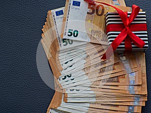 Gift box on the background of fifty euros banknotes