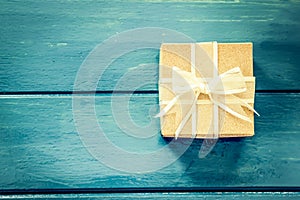 Gift box on blue wooden table