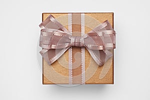 Gift box with bow on light grey background, top view