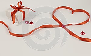 Gift box with bow and lined heart with red ribbon and hearts. Composition for Valentine's Day.