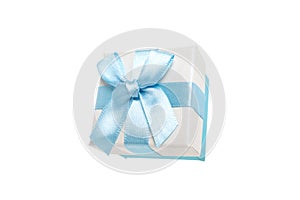 Gift box with a bow for rings in a delicate color of blue and beige. Surprise for a birthday party, a new year event and