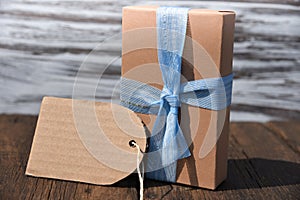 Gift box with bow on wood table front view