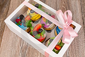 Gift box with cakes of different colors