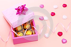 Gift box and chocolates with curly ribbon