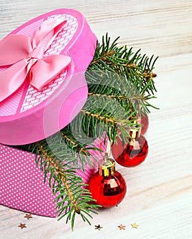 Gift box with christmas baubles and pinetree