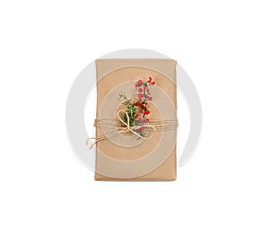 Gift box for Christmas and New Year from craft paper  white background. Handmade decor with natural plants