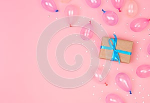 Gift box composition with decorations and balloon, confetti on pink pastel background. birthday, new year concept. Flat lay, top